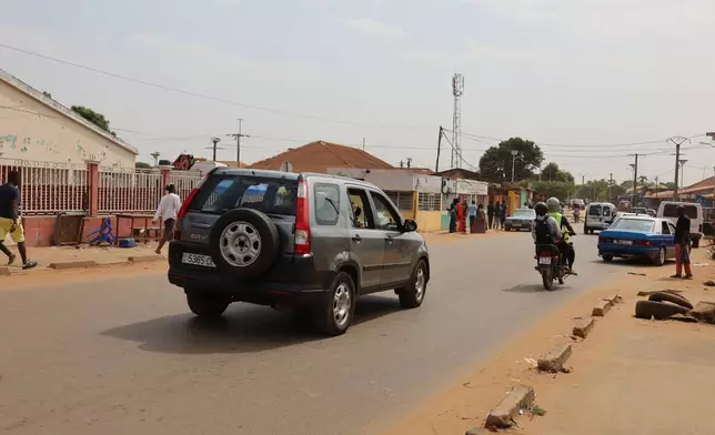 Cars drive on the street in Bissau, Guinea-Bissau, Wednesday, Nov. 26, 2025. (AP Photo/Darcicio Barbosa)