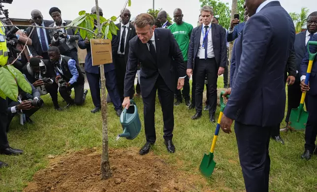 France's President Emmanuel Macron, left, and Gabon's President Brice Oligui Nguema plant a tree as they visit the Baie des Rois eco-district in Libreville, Gabon, Monday, Nov. 24, 2025. (AP Photo/Thibault Camus)
