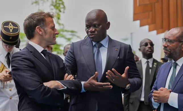 Gabon's President Brice Oligui Nguema, right, gestures as he speaks to France's President Emmanuel Macron, as they visit the Baie des Rois eco-district in Libreville, Gabon, Monday, Nov. 24, 2025. (AP Photo/Thibault Camus)