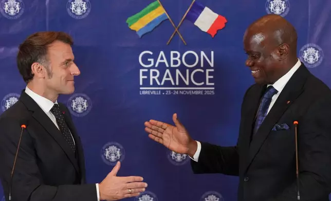 French President Emmanuel Macron, left, and Gabon's President Brice Oligui Nguema shake hands during a press conference following their meeting in Libreville, Gabon, Sunday, Nov. 23, 2025. (AP Photo/Thibault Camus)