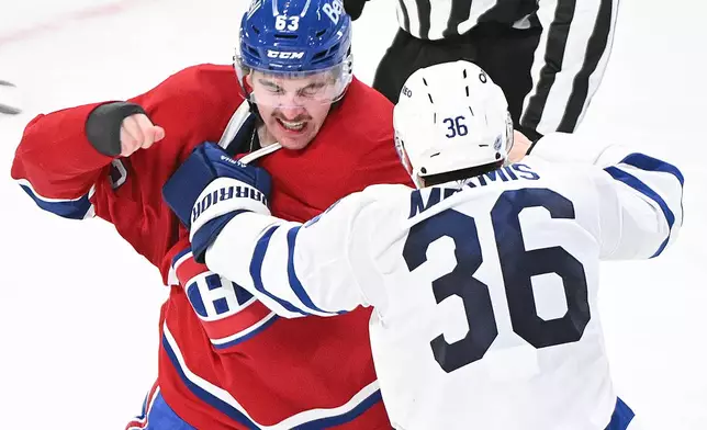 Montreal Canadiens' Florian Xhekaj, right, fights with Toronto Maple Leafs' Dakota Mermis (36) during the third period of an NHL hockey game in Montreal, Saturday, Nov. 22, 2025. (Graham Hughes/The Canadian Press via AP)