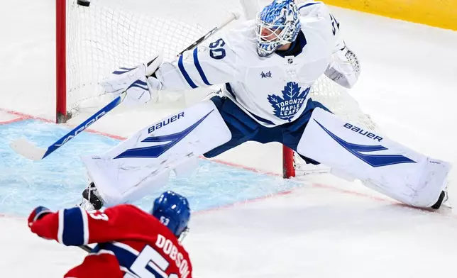 Montreal Canadiens' Noah Dobson (53) scores against Toronto Maple Leafs goaltender Joseph Woll (60) during second period NHL hockey action in Montreal, Saturday, Nov. 22, 2025. (Graham Hughes/The Canadian Press via AP)