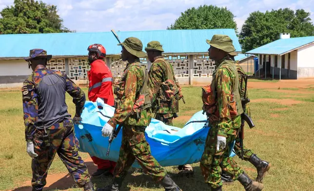 Rescue teams carry bodies of victims of a landslide in the hilly area of Chesongoch in Elgeyo Marakwet county, western Kenya, Sunday, Nov. 2, 2025. (AP Photo/Andrew Kasuku)