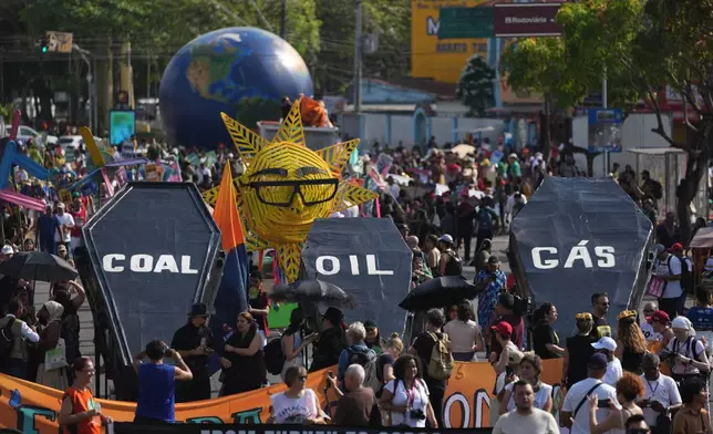Climate activists protest with coffins that read coal, oil and gas during the COP30 U.N. Climate Summit, Saturday, Nov. 15, 2025, in Belem, Brazil. (AP Photo/Andre Penner)