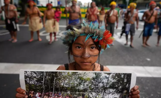 An Indigenous activist demonstrates for protecting the Amazon at a climate protest during the COP30 U.N. Climate Summit, Saturday, Nov. 15, 2025, in Belem, Brazil. (AP Photo/Fernando Llano)