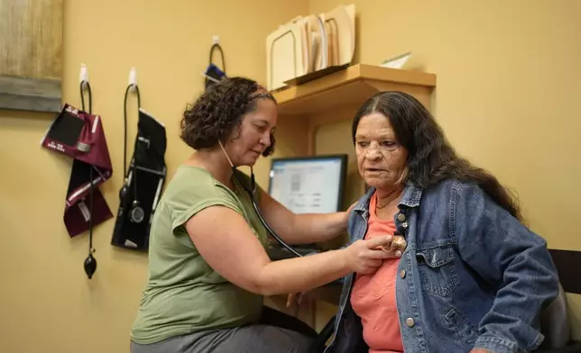 Dr. Melissa Buddensee, left, meets with patient Susan Bushby at Ammonoosuc Community Health Services, Tuesday, Oct. 21, 2025, in Franconia, N.H., in the final days before the clinic closes for good. (AP Photo/Robert F. Bukaty)