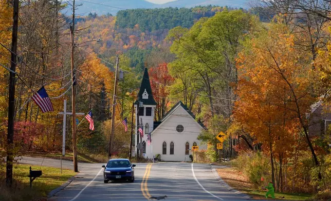 Fall foliage colors the scene near the Community Church, Tuesday, Oct. 21, 2025, in Sugar Hill, N.H., a rural area where the closure of a community health center is leaving residents without nearby medical care. (AP Photo/Robert F. Bukaty)