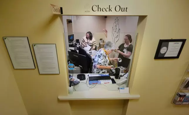 Employees at Ammonoosuc Community Health Services pack up the reception office as the clinic closes for good, Thursday, Oct. 23, 2025, in Franconia, N.H. (AP Photo/Robert F. Bukaty)