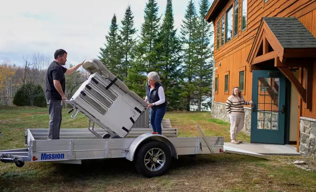 An exam table is moved onto a trailer on the final day of operation at Ammonoosuc Community Health Services as the clinic closes for good, Thursday, Oct. 23, 2025, in Franconia, N.H. (AP Photo/Robert F. Bukaty)