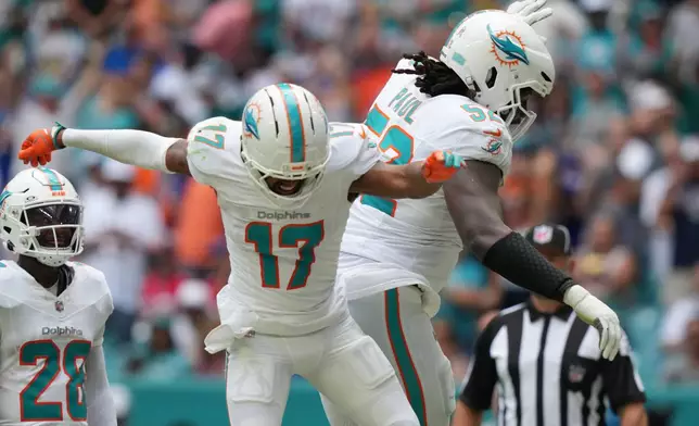 Miami Dolphins' Jaylen Waddle celebrates a touchdown during the first half of an NFL football game against the Buffalo Bills, Sunday, Nov. 9, 2025, in Miami Gardens, Fla. (AP Photo/Lynne Sladky)