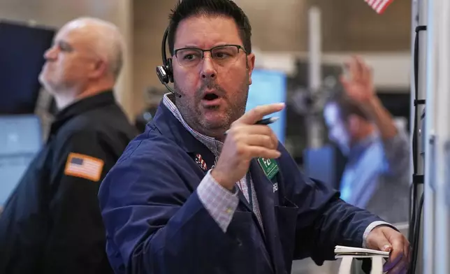 Options trader Andrew Longaro works on the floor of the New York Stock Exchange, Wednesday, Nov. 5, 2025. (AP Photo/Richard Drew)