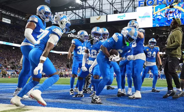 Detroit Lions cornerback Terrion Arnold (6), middle, celebrates with teammates after intercepting a pass during the first half of an NFL football game against the Minnesota Vikings Sunday, Nov. 2, 2025, in Detroit. (AP Photo/Ryan Sun)