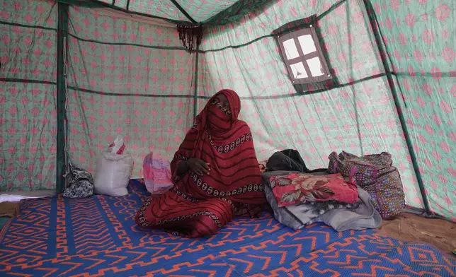 Nadra Mohamed Ahmed, 21, speaks during an interview with The Associated Press inside her tent at the newly established El-Afadh camp in Al Dabbah, Sudan's northern state, Monday, Nov. 17, 2025. (AP Photo/Marwan Ali)