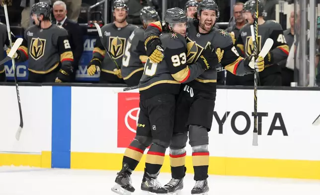Vegas Golden Knights right wing Mitch Marner (93) and right wing Mark Stone (61) celebrate after Marner's goal against the San Jose Sharks during the second period of an NHL hockey game Saturday, Nov. 29, 2025, in Las Vegas. (AP Photo/Ian Maule)