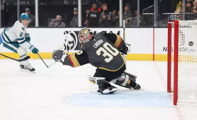 San Jose Sharks center Will Smith (2) scores a goal past Vegas Golden Knights goaltender Carl Lindbom (30) during the first period of an NHL hockey game, Saturday, Nov. 29, 2025, in Las Vegas. (AP Photo/Ian Maule)