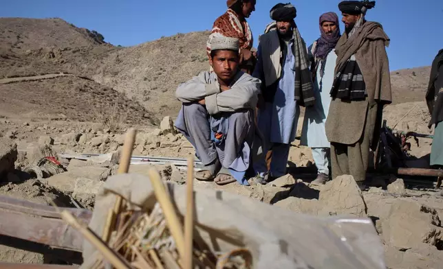 An Afghan boy sits beside the rubble of a home struck in an overnight attack that, according to an Afghan government spokesman, was carried out by Pakistan, in the Gurbaz district of Khost province, Afghanistan, Tuesday, Nov. 25, 2025. (AP Photo/Saifullah Zahir)
