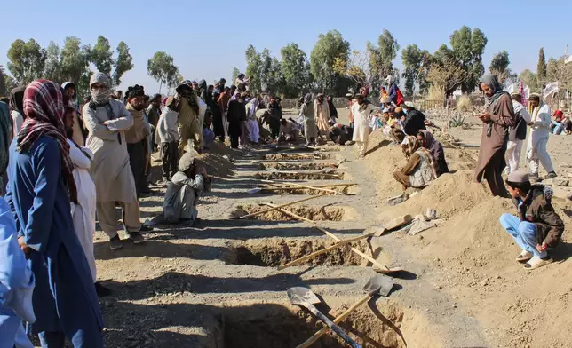 Locals prepare graves for victims of an overnight attack on a home that, according to an Afghan government spokesman, was carried out by Pakistan, in the Gurbaz district of Khost province, Afghanistan, Tuesday, Nov. 25, 2025. (AP Photo/Saifullah Zahir)
