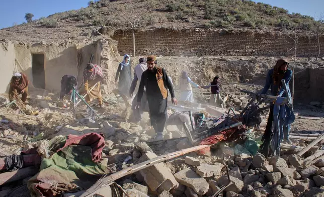 Afghan men search through the rubble at the site of an overnight attack on a home that, according to an Afghan government spokesman, was carried out by Pakistan, in the Gurbaz district of Khost province, Afghanistan, Tuesday, Nov. 25, 2025. (AP Photo/Saifullah Zahir)