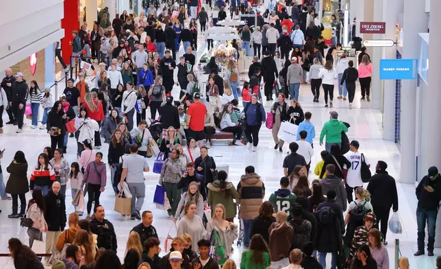 Shoppers browse through stores at Mall of America for Black Friday deals, Friday, Nov. 28, 2025, in Bloomington, Minn. (AP Photo/Adam Bettcher)