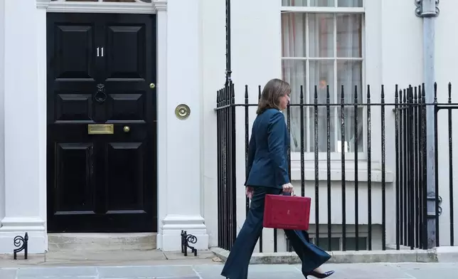 Britain's Chancellor of the Exchequer Rachel Reeves departs 11 Downing Street with her ministerial red box before heading to the House of Commons to deliver her Budget speech in London, Wednesday, Nov. 26, 2025. (AP Photo/Kirsty Wigglesworth)