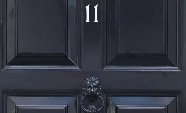 The front door to 11 Downing Street, official home of Britain's Chancellor of the Exchequer Rachel Reeves, who will deliver her governments spending plans later Wednesday to Parliament, in London, Wednesday, Nov. 26, 2025. (AP Photo/Frank Augstein)