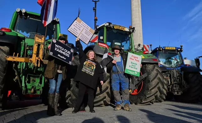 Frames pose with placards demonstrating against inheritance tax in trafalgar Square, ahead of Britain's Chancellor of the Exchequer Rachel Reeves delivering the governments annual spending budget, in London, Wednesday, Nov. 26, 2025. (AP Photo/Thomas Krych)
