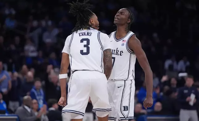 Duke's Dame Sarr (7) celebrates with Isaiah Evans (3) during the first half of an NCAA college basketball game against Kansas Tuesday, Nov. 18, 2025, in New York. (AP Photo/Frank Franklin II)