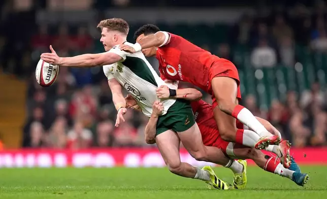South Africa's Ethan Hooker is tackled by Wales's Blair Murray and Rio Dyer during the rugby union international match between Wales and South Africa in Cardiff, Wales, Saturday Nov. 29, 2025. (Andrew Matthews/PA via AP)