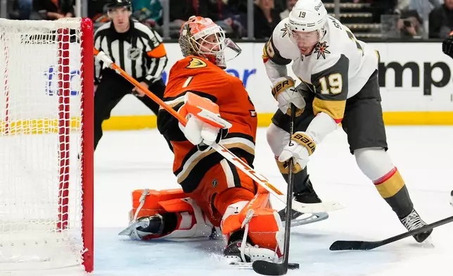 Vegas Golden Knights right wing Reilly Smith, right, tries to get a shot past Anaheim Ducks goaltender Lukas Dostal during the second period of an NHL hockey game Saturday, Nov. 22, 2025, in Anaheim, Calif. (AP Photo/Mark J. Terrill)