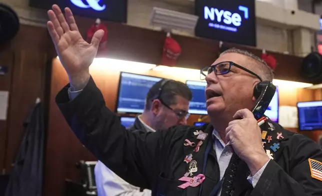 Trader Jonathan Mueller works on the floor of the New York Stock Exchange, Tuesday, Nov. 18, 2025. (AP Photo/Richard Drew)