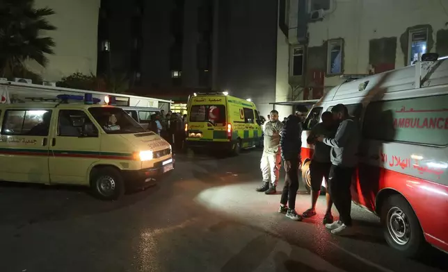 People gathering next of ambulances outside a hospital where they brought the victims of the Israeli strike that hit the Ein el-Hilweh refugee camp in the southern port city of Sidon, Lebanon, Tuesday, Nov. 18, 2025. (AP Photo/Mohammed Zaatari)