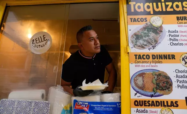 Rafael Hernandez, originally from Mexico, sells food from his family's food truck, Nov. 6, 2025, in Chicago. (AP Photo/Erin Hooley)