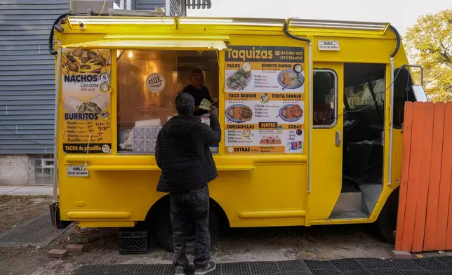 Rafael Hernandez, originally from Mexico, sells food from his family's food truck, Nov. 6, 2025, in Chicago. (AP Photo/Erin Hooley)