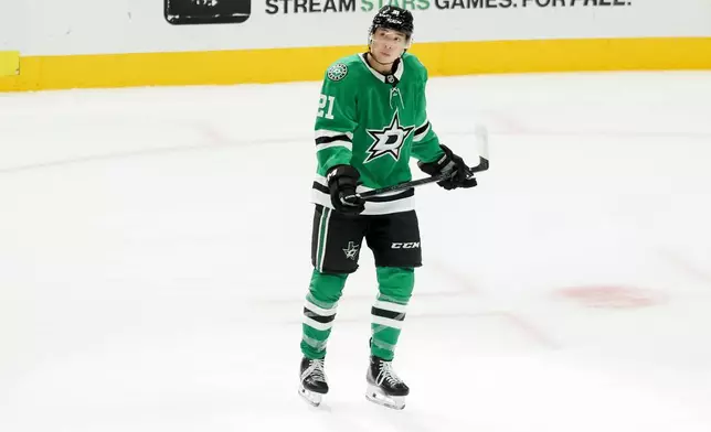 Dallas Stars left wing Jason Robertson (21) skates by himself after scoring during the third period of an NHL hockey game against the New York Islanders, Tuesday, Nov. 18, 2025, in Dallas. (AP Photo/Gareth Patterson)