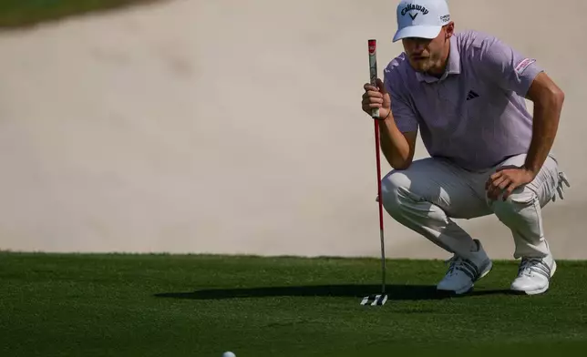 Nicolai Hojgaard of Denmark lines up a putt on the 5th green during the second round of World Tour Golf Championship at Jumeirah Golf Estates, in Dubai, United Arab Emirates, Friday, Nov. 14, 2025. (AP Photo/Altaf Qadri)