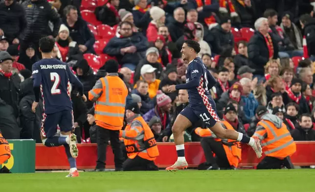 PSV's Couhaib Driouech, right, celebrates after scoring his side's fourth goal during the Champions League opening phase soccer match between Liverpool and PSV in Liverpool, England, Wednesday, Nov. 26, 2025. (AP Photo/Jon Super)