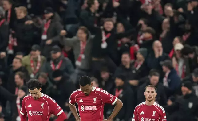 From left: Liverpool's Curtis Jones, Ryan Gravenberch and Alexis Mac Allister react after PSV's Couhaib Driouech scored his side's fourth goal during the Champions League opening phase soccer match between Liverpool and PSV in Liverpool, England, Wednesday, Nov. 26, 2025. (AP Photo/Jon Super)