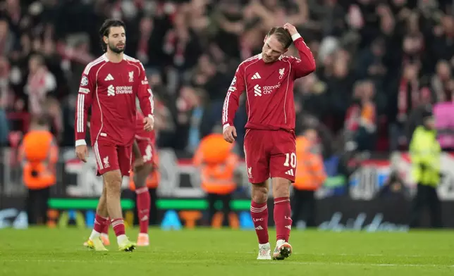 Liverpool's Alexis Mac Allister, right, reacts after the Champions League opening phase soccer match between Liverpool and PSV in Liverpool, England, Wednesday, Nov. 26, 2025. (AP Photo/Jon Super)