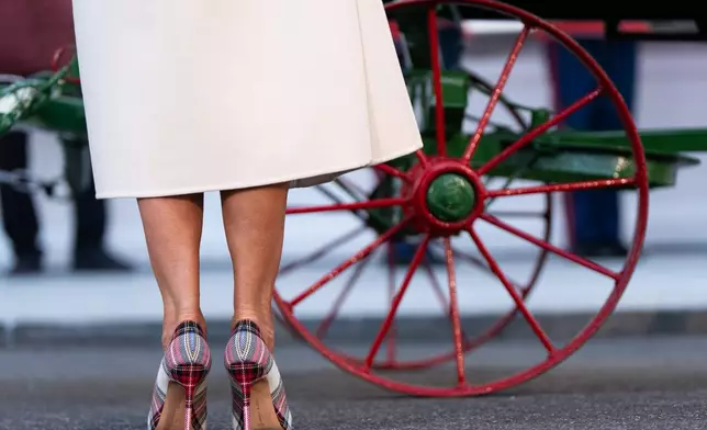 First lady Melania Trump wears Manolo Blahnik pumps while receiving the official 2025 White House Christmas Tree, a white fir from Korson's Tree Farms in Michigan, on the North Portico of the White House, Monday, Nov. 24, 2025, in Washington. (AP Photo/Julia Demaree Nikhinson)