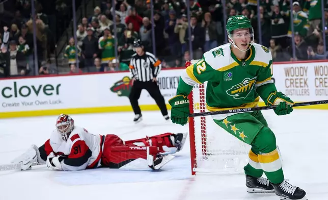Minnesota Wild left wing Matt Boldy (12) reacts to his shootout goal against the Carolina Hurricanes during an NHL hockey game Wednesday, Nov. 19, 2025, in St. Paul, Minn. (AP Photo/Matt Krohn)