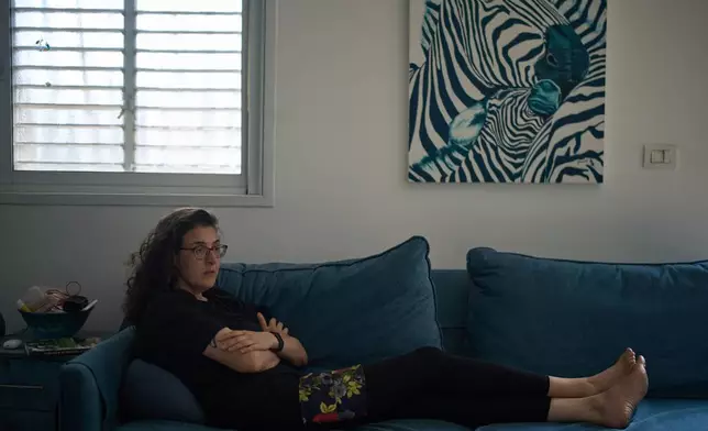 Israeli-Russian doctoral researcher from Princeton University, Elizabeth Tsurkov, who was kidnapped in Iraq, in 2023 and released last September, sits on a sofa during an interview in Ramat Gan, Israel, on Nov. 6, 2025. (AP Photo/Leo Correa)