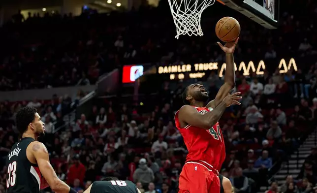 Chicago Bulls forward Patrick Williams, right, shoots over Portland Trail Blazers forward Toumani Camara during the second half of an NBA basketball game in Portland, Ore., Wednesday, Nov. 19, 2025. (AP Photo/Craig Mitchelldyer)