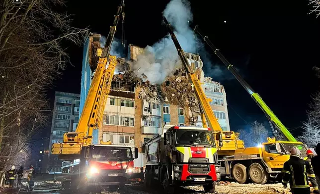In this photo provided by the Ukrainian Emergency Service, firefighters and rescue teams search for trapped people after a Russian attack that hit a multi-storey apartment building in Ternopil, western Ukraine, Thursday, Nov. 20, 2025. (Ukrainian Emergency Service via AP)