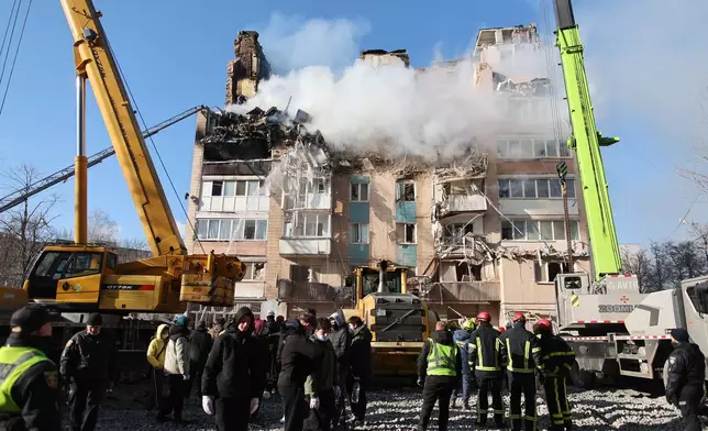 Rescue workers clear the rubble of a residential building which was heavily damaged by a Russian strike on Ternopil, Ukraine, on Wednesday, Nov. 19, 2025. (AP Photo/Vlad Kravchuk)