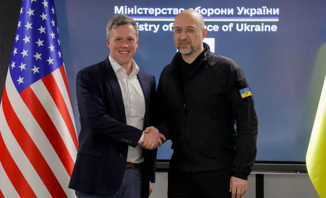 In this photo provided by the Ukrainian Defense Ministry Press Office, Ukrainian Defense Minister Denys Shmyhal, right, shakes hands with US Secretary of the Army Dan Driscoll in Kyiv, Ukraine, Wednesday, Nov. 19, 2025. (Ukrainian Defense Ministry Press Office via AP)