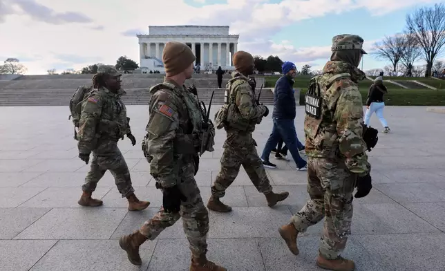 National Guard patrol the National Mall near the Lincoln Memorial, Friday, Nov. 28, 2025, in Washington. (AP Photo/Rahmat Gul)