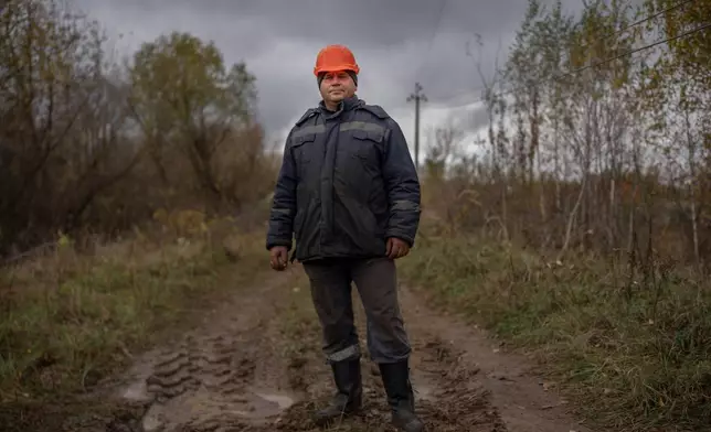 Serhii Staroselskyi, 37, a section supervisor, poses for a portrait while repairing power lines damaged following a Russian attack, Thursday, Oct. 16, 2025, in Shostka, Ukraine. "It's always rewarding when you restore power and people thank you," he says. "That's the best reward." (AP Photo/Julia Demaree Nikhinson)
