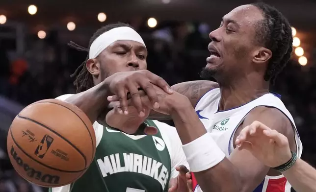 Milwaukee Bucks' Myles Turner knocks the ball from Detroit Pistons' Ronald Holland II during the first half of an NBA basketball game Saturday, Nov. 22, 2025, in Milwaukee. (AP Photo/Morry Gash)