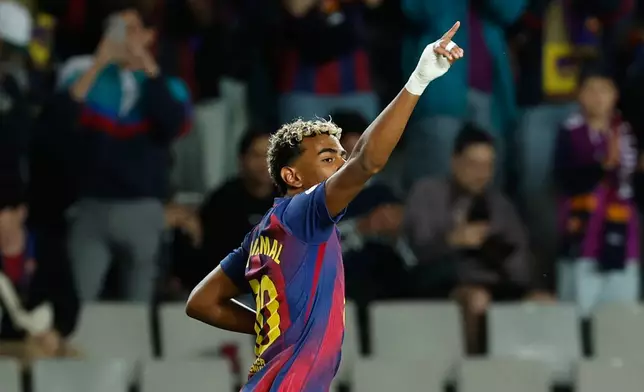 Barcelona's Lamine Yamal celebrates after scoring his side's opening goal during a Spanish La Liga soccer match between FC Barcelona and Elche CF in Barcelona, Spain, Sunday, Nov. 2, 2025. (AP Photo/Joan Monfort)