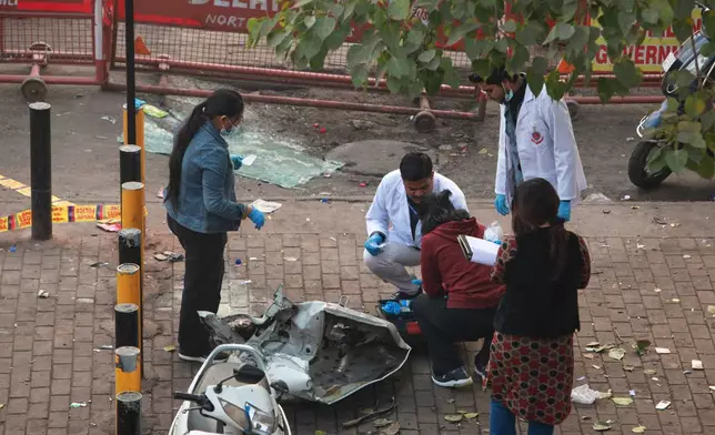 Investigators examine the site of Monday's car explosion near the historic Red Fort, in New Delhi, India, Tuesday, Nov. 11, 2025. (AP Photo)